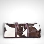 Experience luxury travel with our Real hair on Leather Duffel Bag. Perfect for weekends or gym sessions, this spacious Brown Weekender Bag offers both style and durability.